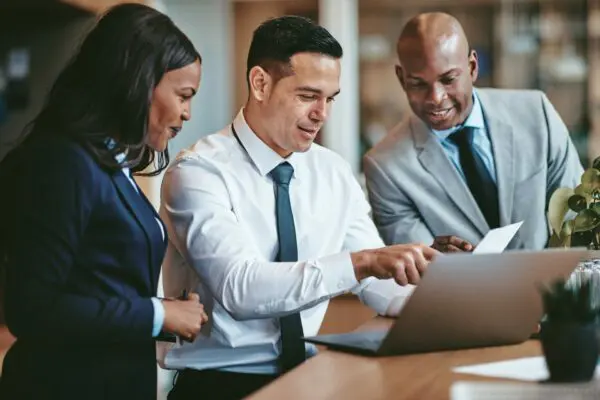 Three Businesspeople Looking At Paper
