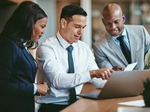 Three Businesspeople Looking At Paper